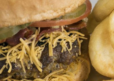 Hickory Bacon Burger - Pearl’s signature patty of brisket and ground beef is grilled to order, dressed, and topped with smoked bacon, rich hickory BBQ sauce, and fresh grated Cheddar cheese.